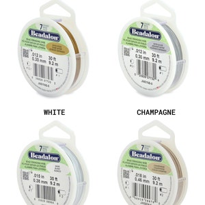 May include: Four spools of Beadalon bead stringing wire in satin gold, satin silver, white, and champagne. Each spool is labeled with the wire thickness in inches and millimeters, and the length in feet and meters.
