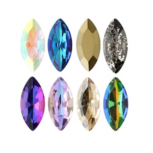 May include: Assortment of eight marquise-shaped rhinestones in various colors, including iridescent, blue, gold, black, purple, lavender, champagne, and green.