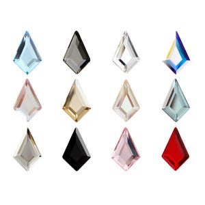 May include: A collection of twelve kite-shaped faceted crystals arranged in a grid. The crystals feature various colors including light blue, black, clear, iridescent, pale pink, gold, beige, teal, silver, and red, each with sharp geometric edges.