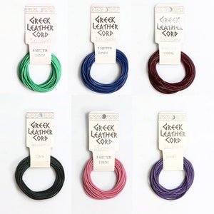 May include: Six spools of 5 metre, 2.0 mm thick, Greek leather cord in various colours: green, blue, burgundy, black, pink, and purple. Each spool has a label that reads "Greek Leather Cord" and "Beadsmith".
