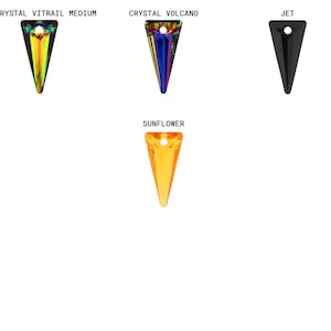May include: Four different colored crystal pendants in the shape of a triangle. The colors are rainbow, blue, black, and orange.