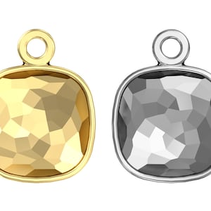 May include: Two square-shaped pendants with a faceted design. One pendant is gold and the other is silver.