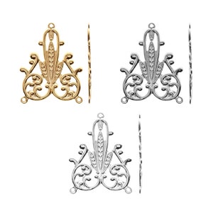 May include: Two sets of ornate metal filigree charms, one in gold and one in silver. Each set features a triangular design with intricate floral patterns.