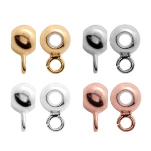 May include: Six round bead caps with a loop on top and a small spike on the bottom. The bead caps are available in gold, silver, and rose gold.