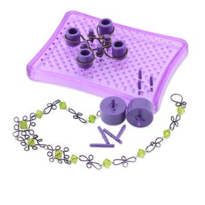 May include: Purple plastic jewelry making kit with a variety of tools and a finished necklace with green beads.