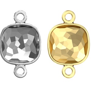 May include: Two square-shaped pendant charms with a faceted design. One charm is silver and the other is gold.