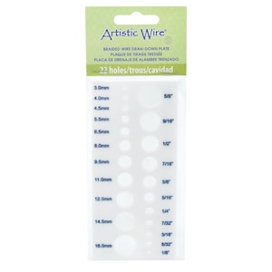 Può includere: Piastra in plastica bianca con 22 fori di diverse dimensioni per intrecciare il filo. La piastra è etichettata "Artistic Wire" e include misure in millimetri e pollici.