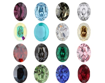 May include: Assortment of oval-shaped gemstones in various colors, including red, blue, green, pink, black, and clear. The gemstones are arranged in three rows of four.