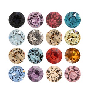 May include: A collection of sixteen round, faceted gemstones arranged in a four-by-four grid. The stones feature a variety of colours including black, light pink, deep red, teal, pale blue, grey, tan, yellow, light brown, bright red, orange, and purple.