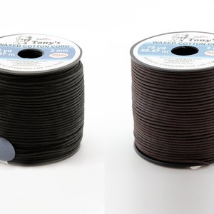 May include: Two spools of waxed cotton cord, one black and one brown. Each spool is labelled "Tony's Waxed Cotton Cord" and has the measurements "75 yd 68.57 m" and "2 mm".