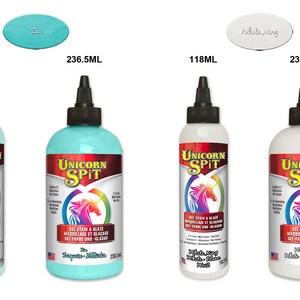 May include: Two bottles of Unicorn Spit gel stain and glaze in turquoise blue and white. The bottles are labeled with the Unicorn Spit logo and the color names "Turquoise Milkshake" and "White Wing White". The bottles are available in two sizes: 118 ml and 236.5 ml.