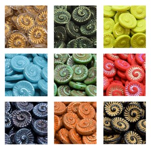 May include: Assortment of colorful glass beads in a variety of colors, including gold, green, blue, red, orange, and black. The beads are shaped like ammonites, with a spiral design.