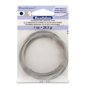 May include: A roll of 1 ounce (28.3 grams) stainless steel memory wire for jewelry making. The wire is silver in color and is packaged in a clear plastic bag with a white label that reads "Remembrance" and "Beadalon".