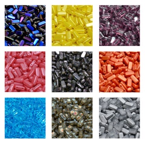 May include: A selection of rectangular beads in diverse colours: iridescent blue, yellow, purple, pink, black, orange, turquoise, brown, and silver. Each bead is rectangular with rounded edges and two holes for stringing, ideal for jewellery making.