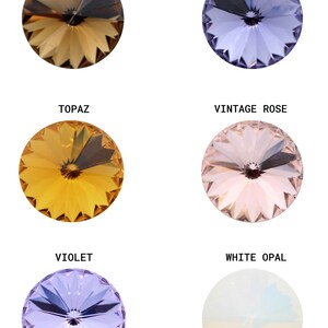 May include: Six round, faceted glass stones in various colors, including smoked topaz, tanzanite, topaz, vintage rose, violet, and white opal. Each stone has a small, clear center.