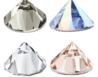 May include: Four different colored rhinestones, each with a pointed top and a flat bottom. The colors are clear, light gray, light blue, and light pink.