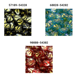 May include: A close-up of three different colors of glass heart-shaped beads. The beads are all translucent and have a gold leaf design. The colors are black, teal, and red.