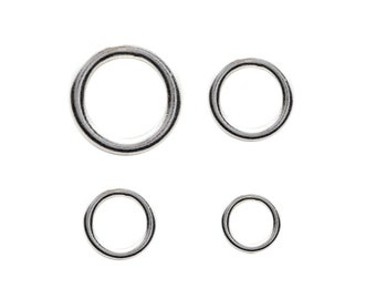 May include: Four silver jump rings of different sizes. The rings are smooth and shiny.
