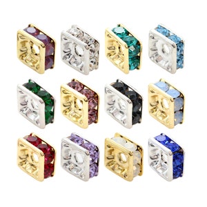 May include: Twelve square-shaped bead caps with a gold rim and a hole in the centre. Each cap is adorned with two rows of colourful crystals. The colours include clear, green, blue, purple, black, and red.
