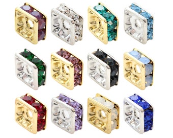 May include: Twelve square-shaped bead caps with a gold rim and a hole in the center. Each cap is adorned with two rows of colorful crystals. The colors include clear, green, blue, purple, black, and red.