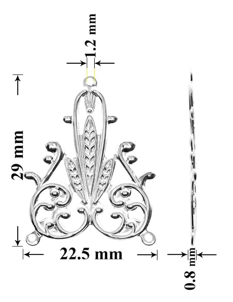May include: Silver filigree pendant with a floral design, measuring 29 mm tall, 22.5 mm wide, and 1.2 mm thick.
