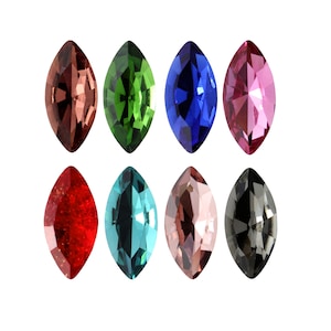 Puede incluir: Ocho piedras de imitación en forma de marquesa en varios colores, incluyendo rojo, verde, azul, rosa, turquesa y negro.