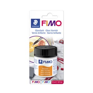 May include: A bottle of FIMO Gloss Varnish, 1.18 fl oz, with a black cap and white label. The label includes the text "Glanzlack Gloss Varnish Vernis brillante Barniz brillante". The product is packaged on a white card with the Staedtler logo.
