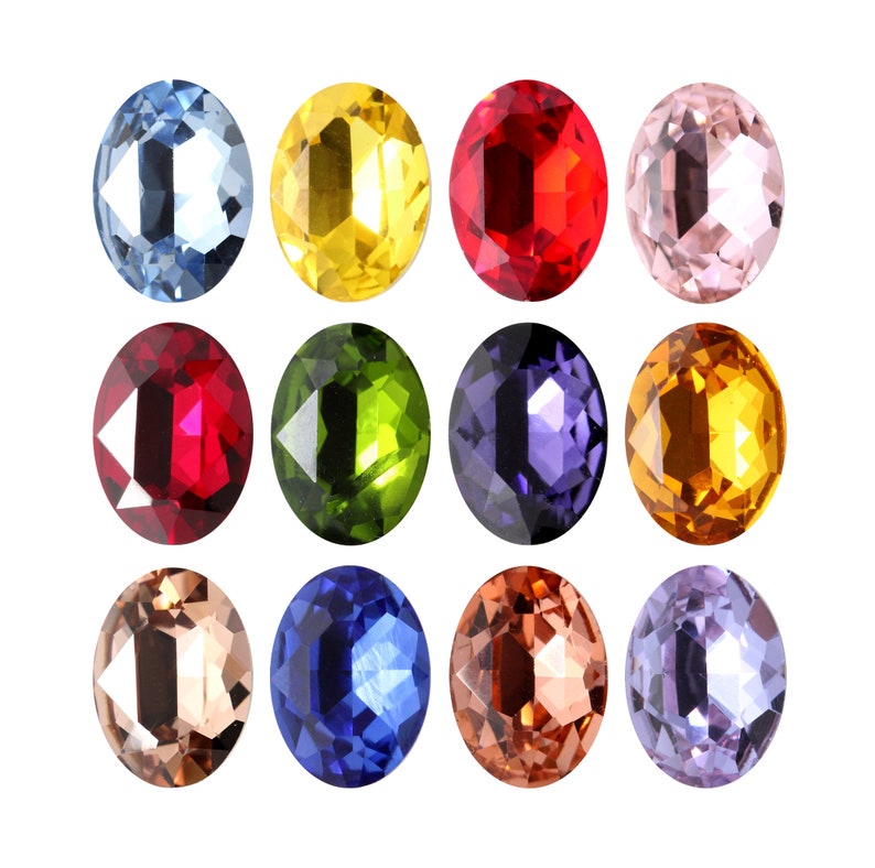 Pode incluir: Doze gemas ovais de v&aacute;rias cores, incluindo vermelho, azul, verde, amarelo e roxo. As gemas est&atilde;o dispostas em tr&ecirc;s filas de quatro.