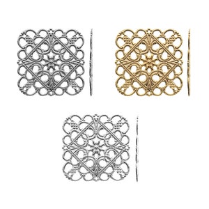 May include: Three square metal filigree embellishments in silver, gold, and antique silver. Each embellishment has a delicate, intricate design with a diamond shape in the center.