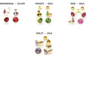 May include: Assortment of gold-tone metal settings with colorful rhinestones. The settings are for attaching rhinestones to fabric or other materials. The colors include red, green, pink, and purple.