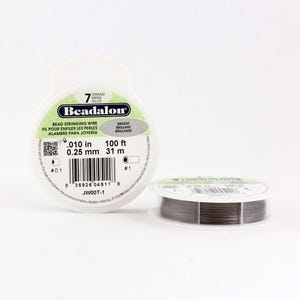 May include: A spool of 7-strand Beadalon bead stringing wire. The wire is 0.010 inches (0.25 mm) thick and comes in a 100-foot (31-meter) spool. The spool is white with black text and a barcode.