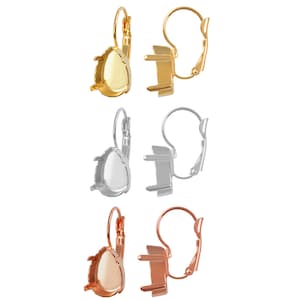 May include: Three pairs of earring settings in gold, silver, and rose gold. Each setting features a teardrop-shaped bezel and a lever back closure.