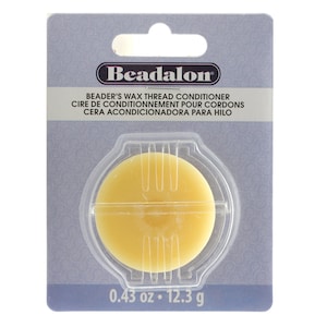 May include: A round, yellow Beadalon wax thread conditioner in a clear plastic container. The label reads "Beadalon Beader's Wax Thread Conditioner Cire de Conditionnement pour Cordons Cera Acondicionadora para Hilo 0.43 oz. 12.3 g".