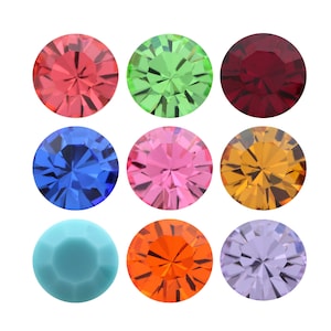 May include: Nine round, faceted, colourful glass gems. The gems are red, green, blue, pink, orange, purple, and turquoise.