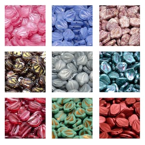 May include: Assortment of glass beads in various colors and patterns, including pink, blue, brown, white, teal, green, and red. The beads are shaped like leaves and have a glossy finish.