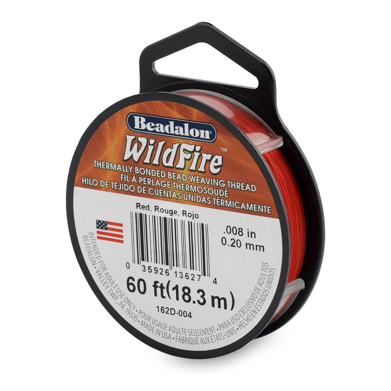 May include: A spool of red Beadalon WildFire thermally bonded bead weaving thread. The spool is labeled with the text "Beadalon WildFire Thermally Bonded Bead Weaving Thread, Fil &agrave; Perlage Thermosoud&eacute;, Hilo de Tejido de Cuentas Unidas Termicamente." The spool is also labeled with the text "Red, Rouge, Rojo" and "0.008 in 0.20 mm". The spool is labeled with the text "60 ft (18.3 m)" and "162D-004".
