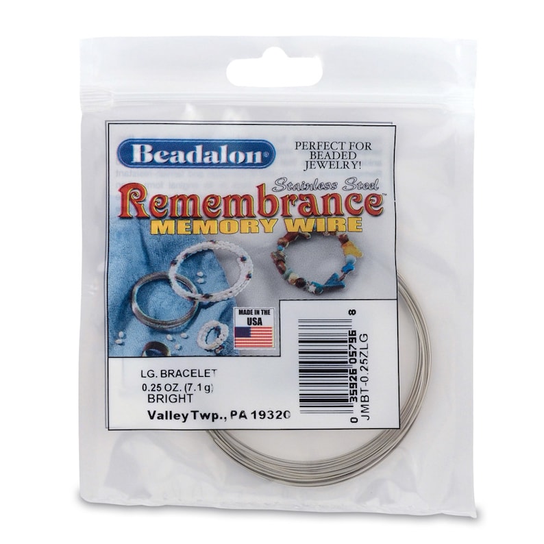 May include: A package of silver-colored stainless steel memory wire for jewelry making. The package is labeled "Beadalon Remembrance Memory Wire" and includes the text "LG. BRACELET 0.25 OZ. (7.1 g) BRIGHT Valley Twp., PA 19320".