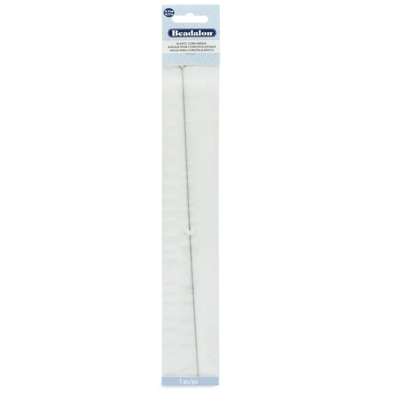 May include: A silver elastic cord needle for beading and jewelry making. The needle is packaged in a clear plastic bag with a blue and white label that reads "Beadalon Elastic Cord Needle, Aiguille pour cordon elastique, Aguja para cordon elastico".
