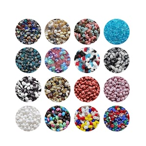 May include: A selection of colourful beads in various shades, including blue, pink, red, and white. The beads are arranged in circular patterns, showcasing their diverse colours and textures. Ideal for jewellery making and crafting.