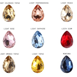 May include: Nine teardrop-shaped crystal beads in various colors, including light Colorado topaz, light padparadscha, light peach, light rose, light sapphire, light Siam, light smoked topaz, light topaz, and Montana.