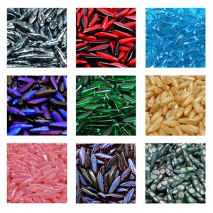 May include: Assortment of glass beads in various colors and patterns. The beads are long and narrow, resembling rice grains. Colors include blue, green, red, purple, pink, and brown.