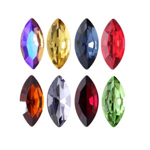 May include: Assortment of eight marquise-shaped rhinestones in various colours, including red, green, blue, purple, gold, and silver.