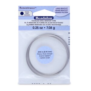 May include: A roll of 0.036 inch (0.91 mm) stainless steel memory wire. The wire is heavy duty gauge and is packaged in a clear plastic bag with a white label that reads "Beadalon Stainless Steel Memory Wire" and "0.25 oz 7.08 g".