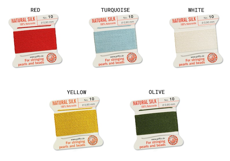 May include: Five spools of natural silk thread for stringing pearls and beads. The spools are labeled with the colors red, turquoise, white, yellow, and olive.