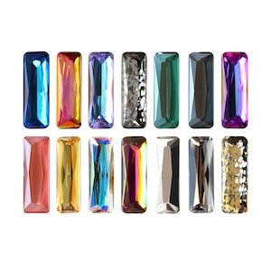 May include: Assortment of 12 rectangular iridescent glass gems in various colours, including blue, green, red, gold, and silver. The gems have a faceted cut and a smooth, polished finish.