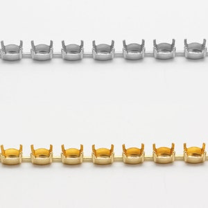May include: Two rows of silver and gold metal settings for rhinestones. The settings are connected together in a chain.