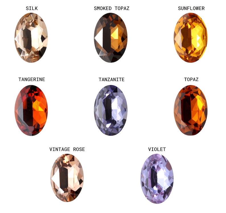 Pode incluir: Nove pedras preciosas ovais em v&aacute;rias cores, incluindo bege, marrom, laranja, amarelo, roxo e azul. As pedras preciosas s&atilde;o etiquetadas com seus nomes: Seda, Top&aacute;zio Fumado, Girassol, Tangerina, Tanzanita, Top&aacute;zio, Rosa Vintage e Violeta.