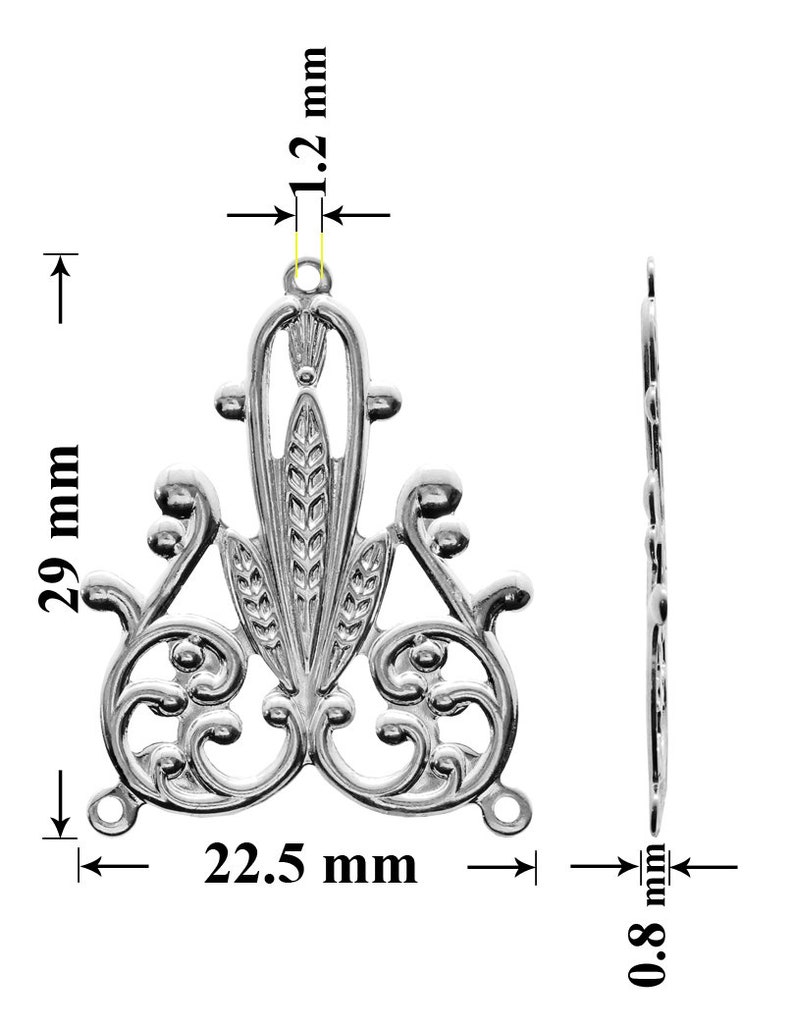May include: Silver-toned metal pendant with a decorative design featuring a stylized floral motif. The pendant measures 29 mm in height, 22.5 mm in width, and 1.2 mm in thickness.