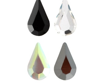 May include: Four teardrop-shaped crystal rhinestones in black, clear, iridescent, and gray.