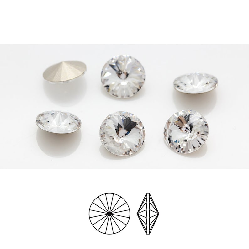 May include: Five clear crystal rhinestones with a flat back and a faceted top. The rhinestones are arranged in a semi-circle on a white surface. A line drawing of the rhinestone's top and side view is shown below.